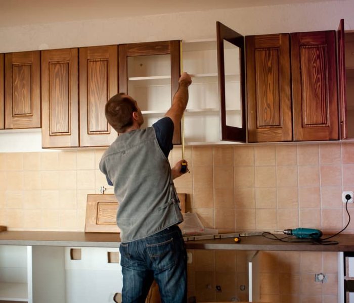 Carpenter,Working,On,New,Kitchen,Cabinets